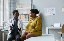 Black doctor and patient going over paperwork