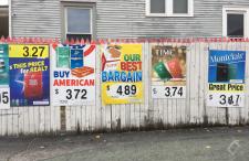 Tobacco Advertisement Posters on a Gas Station Fence