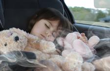 Child sleeping in car with smoke