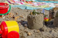 beach with beach toys and ciagrette butts