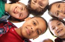 A group of kids looking into the camera