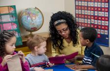 Child care worker reading to children