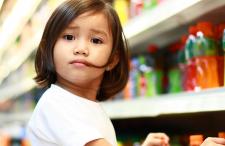 Kid in soda aisle at the store