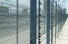 barbed wire and fencing around a detention facility 