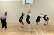 Kids jumping rope with gym coach