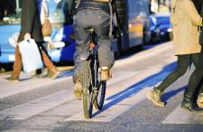 Cyclist crossing pedestrian crosswalk and entering bike lane