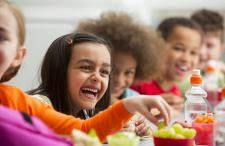 Girl laughing with friends at the lunch table