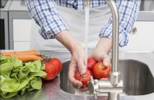 Washing tomatoes in the sink