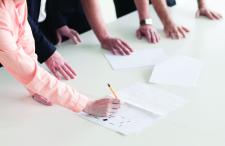 Person writing during a meeting