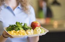 Cafeteria tray mostly filled with vegetables and fruit and one portion of macaroni and cheese