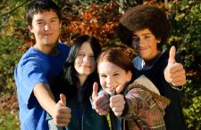 Four kids giving the thumbs up