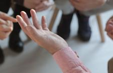 Hands of people sitting in a discussion circle