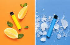 Yellow e-cigarette surrounded by lemons and blue e-cigarette surrounded by ice